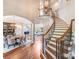 The foyer features a grand staircase, hardwood floors, elegant lighting, and access to the dining and living spaces at 600 Beauhaven Ln, Waxhaw, NC 28173