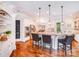 Spacious white kitchen featuring a granite countertop island with barstool seating and pendant lights at 600 Beauhaven Ln, Waxhaw, NC 28173