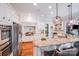 Bright kitchen with white cabinets, granite counters, stainless steel appliances, and hardwood floors at 600 Beauhaven Ln, Waxhaw, NC 28173