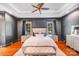 Serene main bedroom with tray ceiling, dark walls, and hardwood floors at 600 Beauhaven Ln, Waxhaw, NC 28173