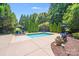 Sparkling in-ground pool is surrounded by lush landscaping and plenty of space for outdoor entertaining at 600 Beauhaven Ln, Waxhaw, NC 28173