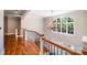 Beautiful staircase with wood and iron railings ascends to a landing with a large window at 600 Beauhaven Ln, Waxhaw, NC 28173