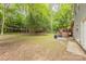 Expansive backyard with a patio and deck area, surrounded by lush trees, perfect for outdoor activities and entertainment at 6418 Tivoli Ct, Charlotte, NC 28211