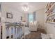 Cute Bedroom with a crib, dresser, recliner and a bookshelf filled with books at 6418 Tivoli Ct, Charlotte, NC 28211