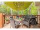 A wooden deck features a table with chairs, umbrella, and a grill, creating a perfect outdoor relaxation space at 6418 Tivoli Ct, Charlotte, NC 28211