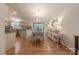 Bright dining area with wood floors, a chandelier, a dining table set, and a view into the kitchen at 6418 Tivoli Ct, Charlotte, NC 28211