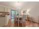 Inviting dining area with wood floors, table with seating for six, and sliding door to outdoor space at 6418 Tivoli Ct, Charlotte, NC 28211