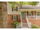 Inviting front porch with brick steps, white railings, black shutters, and a teal front door with decorative wreath at 6418 Tivoli Ct, Charlotte, NC 28211