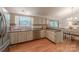 Bright kitchen with stainless appliances, light cabinets, granite counters, and open access to dining area at 6418 Tivoli Ct, Charlotte, NC 28211