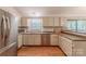Updated kitchen features stainless appliances, light cabinetry, granite counters, and a window at 6418 Tivoli Ct, Charlotte, NC 28211