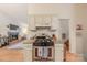 Kitchen view featuring a stainless steel gas range and view into a fireplace equipped living room at 6418 Tivoli Ct, Charlotte, NC 28211