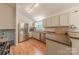 Well-lit kitchen featuring stainless steel appliances, granite countertops, and light wood flooring at 6418 Tivoli Ct, Charlotte, NC 28211