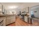 Bright kitchen features light cabinetry, stainless appliances, granite counters, and open layout at 6418 Tivoli Ct, Charlotte, NC 28211