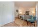 Bright living room with wood floors, a cozy seating arrangement, and a glimpse of a brick fireplace at 6418 Tivoli Ct, Charlotte, NC 28211