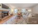 Spacious living room with a brick fireplace, large sectional sofa, area rug, and an abundance of natural light at 6418 Tivoli Ct, Charlotte, NC 28211