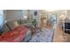 Open-concept living room flowing into the dining area, featuring a large sectional sofa and wood floors at 6418 Tivoli Ct, Charlotte, NC 28211