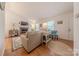 Inviting living room featuring a brick fireplace, wood floors, comfortable seating, and plenty of natural light at 6418 Tivoli Ct, Charlotte, NC 28211
