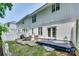 Spacious backyard featuring a blue deck, patio, grill, and an air conditioning unit at 713 Torrey Pines Ln, Fort Mill, SC 29715