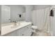 Well-lit bathroom with white cabinets, white counter, and wood-look floors at 713 Torrey Pines Ln, Fort Mill, SC 29715