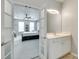 Bright bathroom featuring a vanity with white cabinets and a glimpse into a bedroom at 713 Torrey Pines Ln, Fort Mill, SC 29715