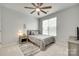 Neutral bedroom boasts a ceiling fan, light gray walls, and a large window at 713 Torrey Pines Ln, Fort Mill, SC 29715