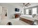Bedroom featuring a dresser with a TV, a storage bed, a ceiling fan and multiple windows for natural light at 713 Torrey Pines Ln, Fort Mill, SC 29715