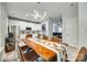 Bright dining area with a wooden table, chandelier, and view of the modern kitchen at 713 Torrey Pines Ln, Fort Mill, SC 29715