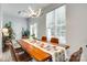 Well-lit dining room featuring a contemporary chandelier, natural wood table, and patio access at 713 Torrey Pines Ln, Fort Mill, SC 29715