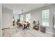 Bright dining area featuring a modern chandelier, stylish furniture, and hardwood floors at 713 Torrey Pines Ln, Fort Mill, SC 29715