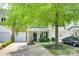 Charming home with a well-manicured lawn, front porch, driveway, and attached garages, with a large tree at 713 Torrey Pines Ln, Fort Mill, SC 29715