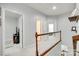 Upstairs hallway featuring white banisters, neutral walls, and views into adjacent rooms at 713 Torrey Pines Ln, Fort Mill, SC 29715