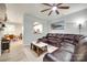 Spacious living room with a ceiling fan, large leather sectional, and open access to the kitchen at 713 Torrey Pines Ln, Fort Mill, SC 29715