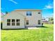 Expansive backyard showing the home's exterior, well-manicured lawn, and patio area at 7339 Dover Mill Sw Dr, Concord, NC 28025