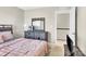 Bedroom featuring neutral color palette, complemented by a dark wood dresser, and a comfortable bed at 7339 Dover Mill Sw Dr, Concord, NC 28025
