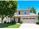 Charming home featuring gray siding, a two-car garage, manicured lawn, and beautiful mature trees at 7339 Dover Mill Sw Dr, Concord, NC 28025