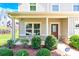 Inviting covered front porch showcasing manicured landscaping and a stylish front door at 7339 Dover Mill Sw Dr, Concord, NC 28025