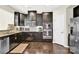 Modern kitchen featuring dark wood cabinets, stainless steel appliances, and granite countertops at 7339 Dover Mill Sw Dr, Concord, NC 28025