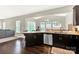 Open kitchen layout with granite countertops, stainless steel appliances, and dark wood floors at 7339 Dover Mill Sw Dr, Concord, NC 28025