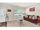 Cozy living room featuring a large window offering plenty of natural light and neutral wall paint at 7339 Dover Mill Sw Dr, Concord, NC 28025