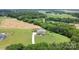 Stunning aerial view of a beautiful home with surrounding greenery and a long driveway at 7805 Crooked Creek Church Rd, Monroe, NC 28110