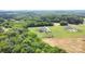 Aerial view showcases the home's large lot, a well-maintained lawn, and surrounding farmland and greenery at 7805 Crooked Creek Church Rd, Monroe, NC 28110
