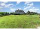 Expansive backyard featuring a wooden fence, green lawn, deck, and trampoline at 7805 Crooked Creek Church Rd, Monroe, NC 28110