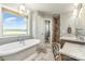 Bathroom with freestanding tub, large window with views, walk-in shower and separate toilet room at 7805 Crooked Creek Church Rd, Monroe, NC 28110
