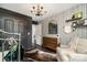 Charming Bedroom with patterned wallpaper, comfortable chair, and stylish decorative accents at 7805 Crooked Creek Church Rd, Monroe, NC 28110