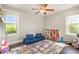 Sunlit bedroom with play area, colorful rug, and ample storage for toys and books at 7805 Crooked Creek Church Rd, Monroe, NC 28110