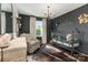 A cozy baby bedroom featuring a stylish crib, chair, chandelier, and elegant décor at 7805 Crooked Creek Church Rd, Monroe, NC 28110
