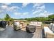 Outdoor deck with a fire pit and comfortable seating, perfect for entertaining guests at 7805 Crooked Creek Church Rd, Monroe, NC 28110