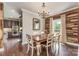 Elegant dining room featuring hardwood floors, a decorative chandelier, and an open floor plan at 7805 Crooked Creek Church Rd, Monroe, NC 28110