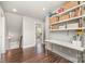 Bright home office space with hardwood floors, work space, and shelving for storage at 7805 Crooked Creek Church Rd, Monroe, NC 28110