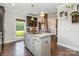 Bright kitchen features a center island with cooktop, plenty of cabinet storage, and natural light at 7805 Crooked Creek Church Rd, Monroe, NC 28110